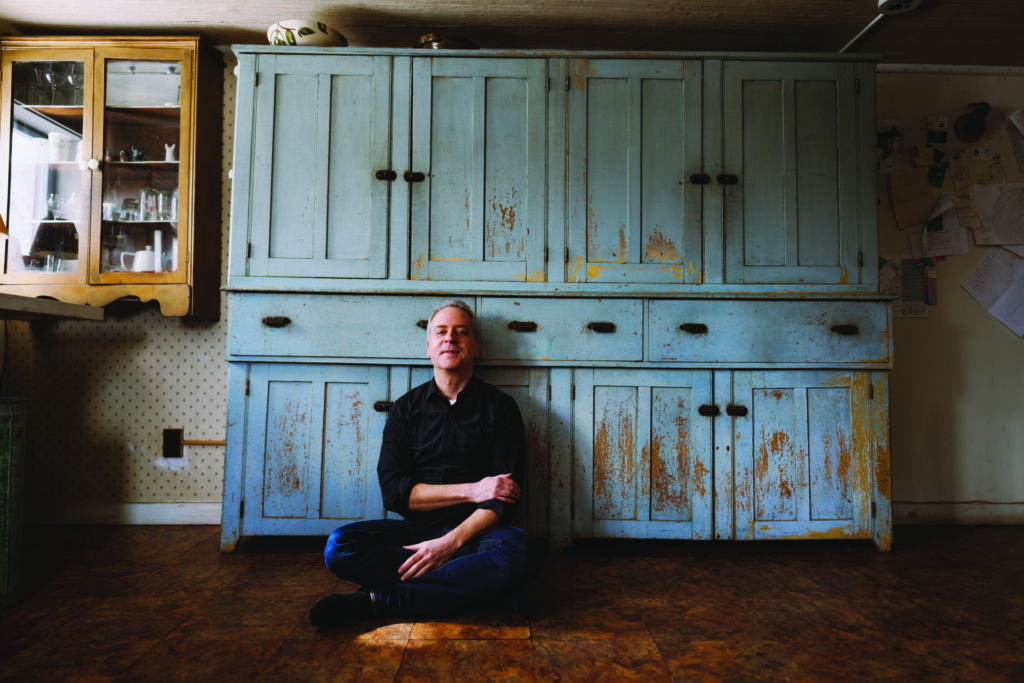 Jeremy Denk seated against a vintage backdrop.