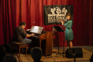 Arturo O'Farrill plays an upright piano facing flutist Elsa Nilsson.